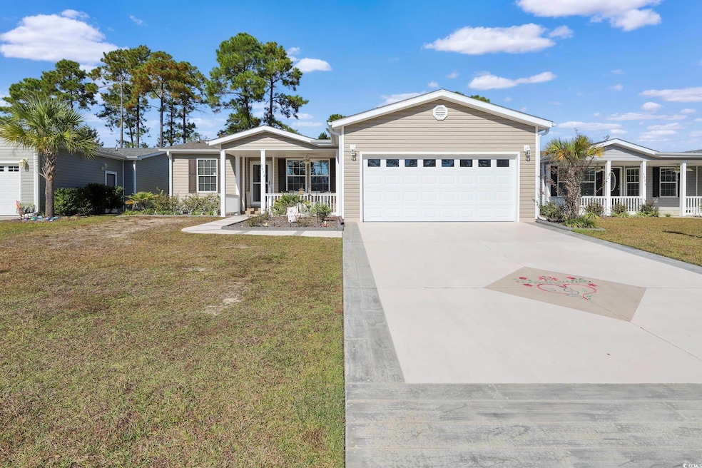 Ranch-style house featuring a porch, a front lawn, driveway, and a garage