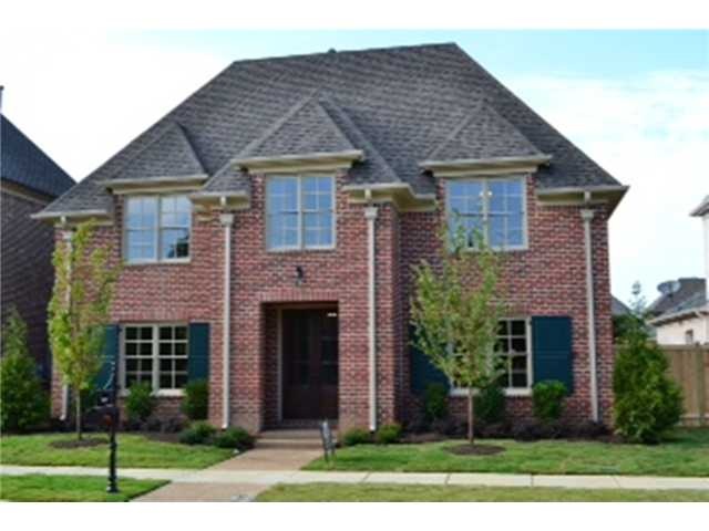 Front of newly finished traditional brick home bui