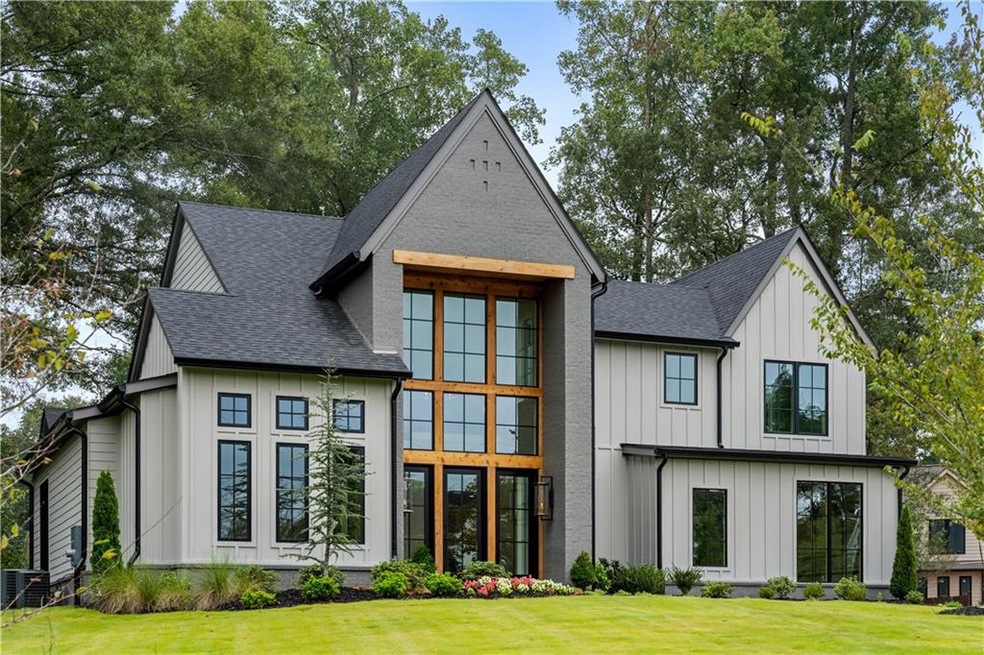 The grand exterior features floor-to-ceiling windo