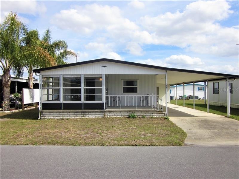 Front of home offer open covered patio and Florida
