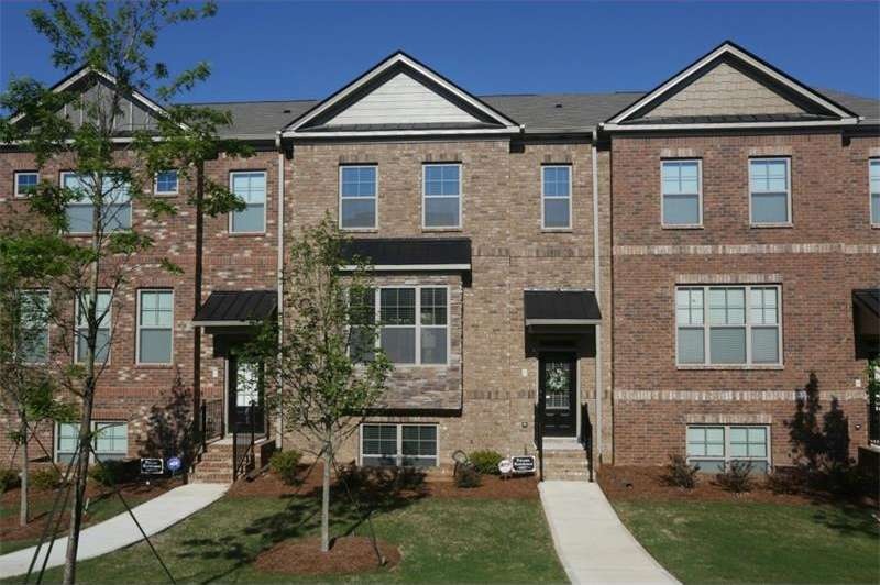 Welcoming, brick townhome with covered front porch