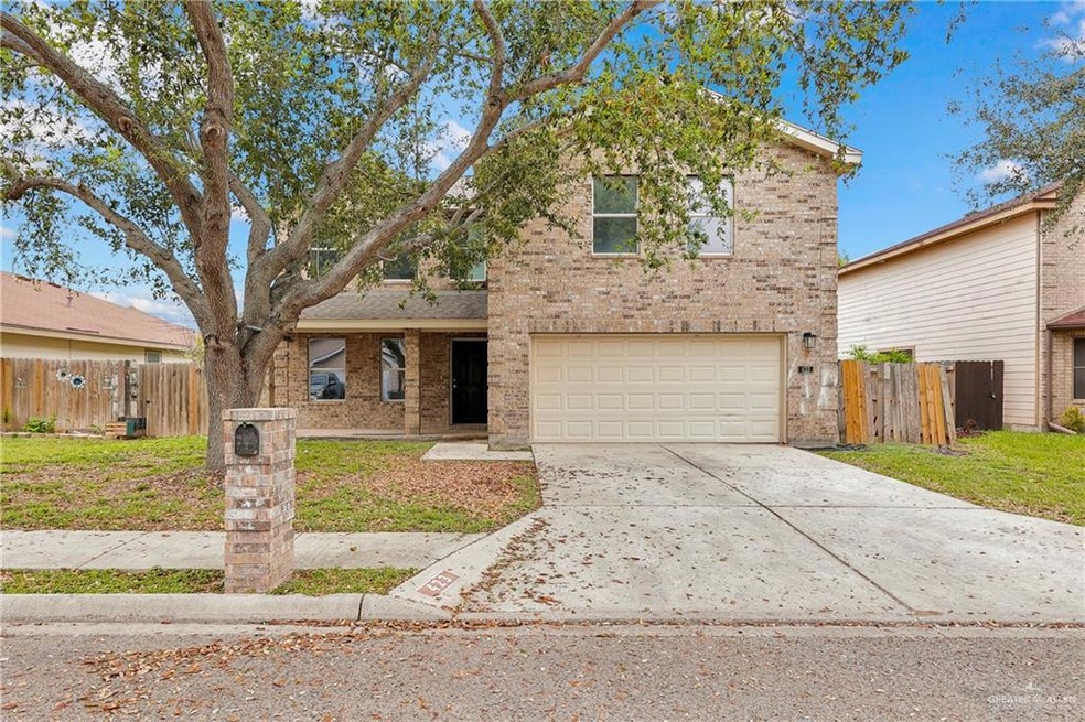 View of property with a garage and a front yard