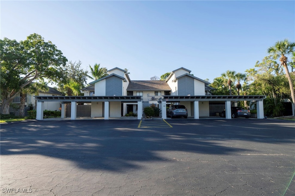 View of property featuring covered parking