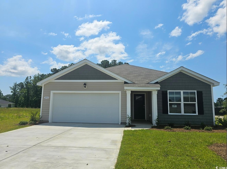 Ranch-style home with a garage and a front lawn