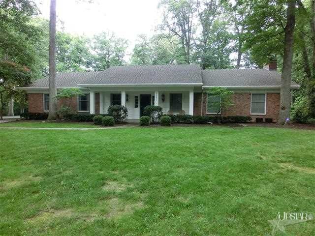 Spacious ranch with over 4400 SF On a wooded acre 