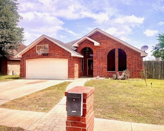 View of front of property featuring brick siding, driveway, and an attached garage