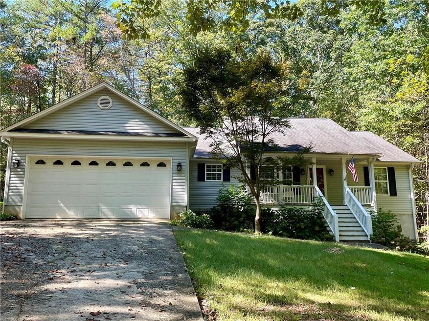Ranch-style home with a garage, a front yard, and 