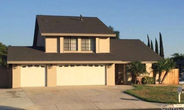 FRONT OF HOME WITH A THREE CAR GARAGE