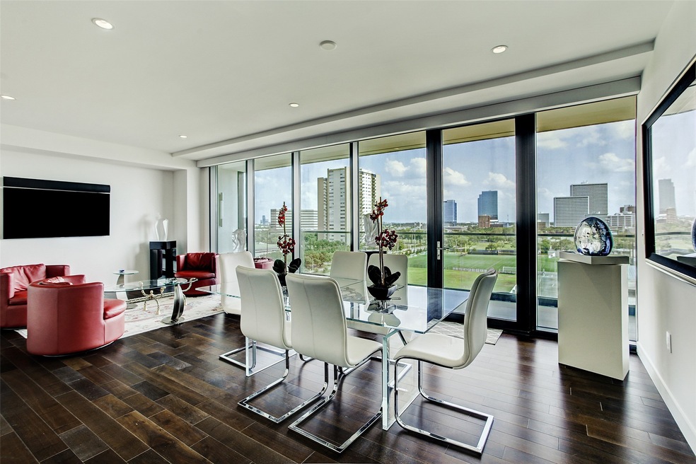 Views through floor to ceiling glass windows.  Open living and dining rooms.