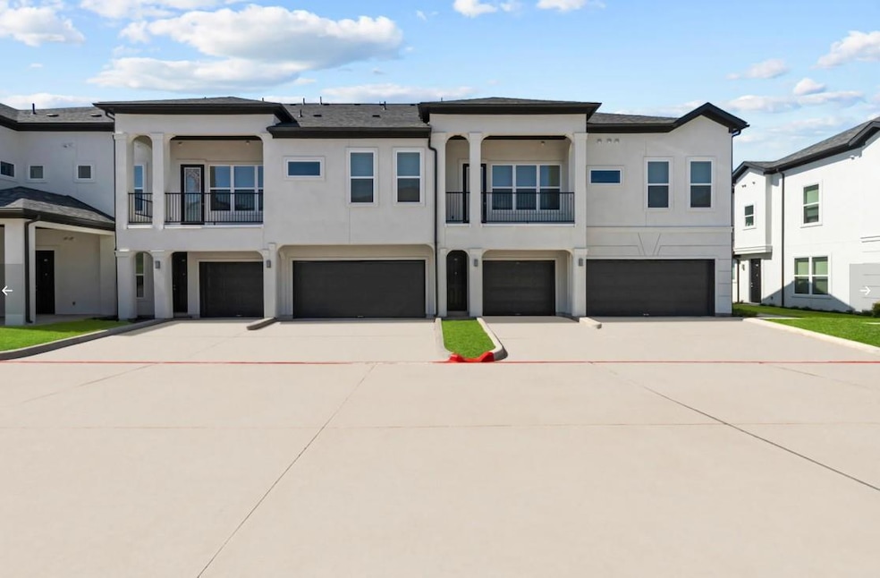 View of property with a garage, stucco siding, dr
