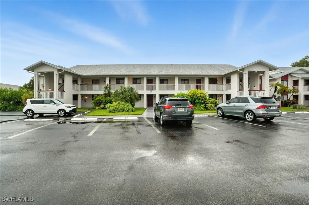 View of building exterior featuring uncovered parking