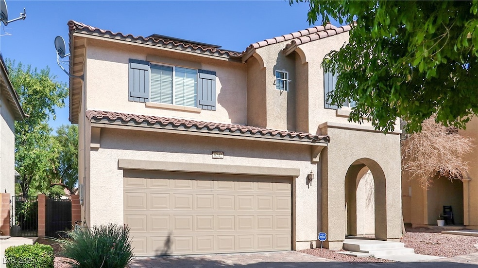Mediterranean / spanish-style home featuring an attached garage, stucco siding, and driveway