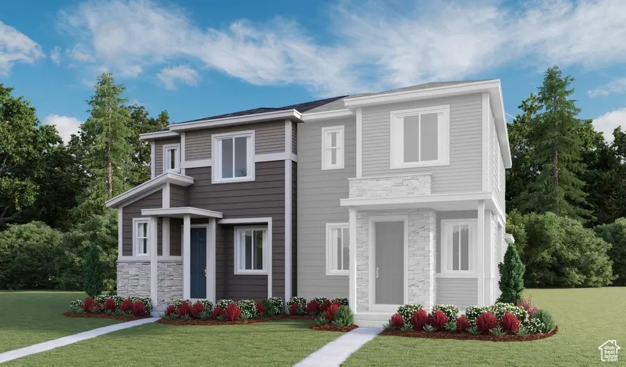 View of front of home with a front yard and stone siding