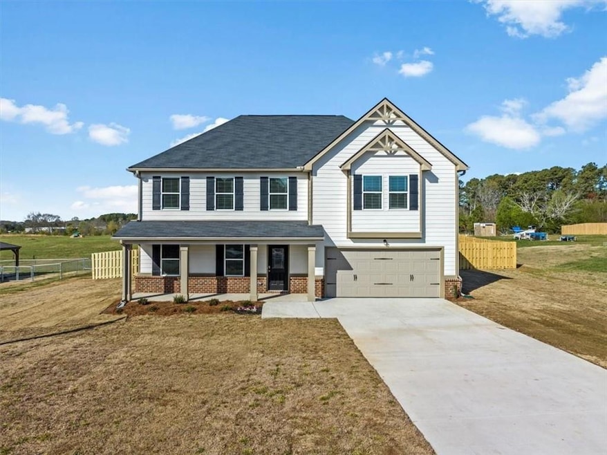 View of front of home with an attached garage, cov
