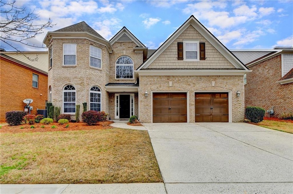 View of front of home with a front lawn, a garage,