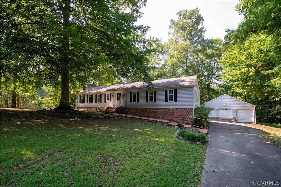 Single story home with a garage, an outbuilding, a