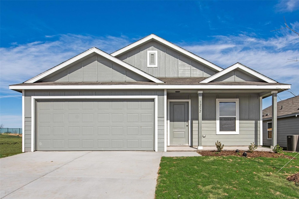 View of front of house with a porch, a garage, and