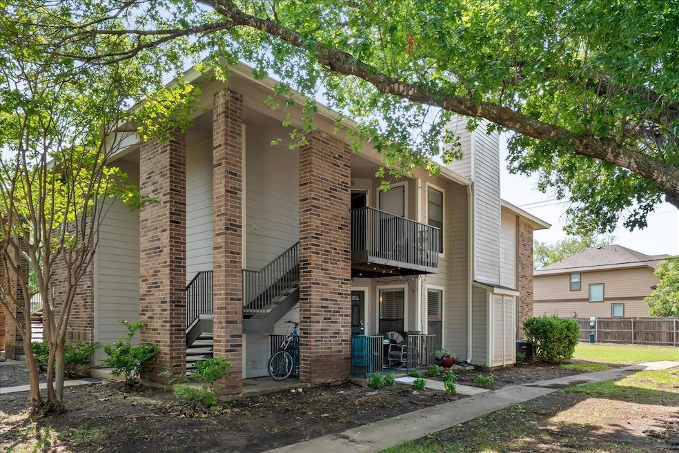 View of front of home with a balcony and brick si