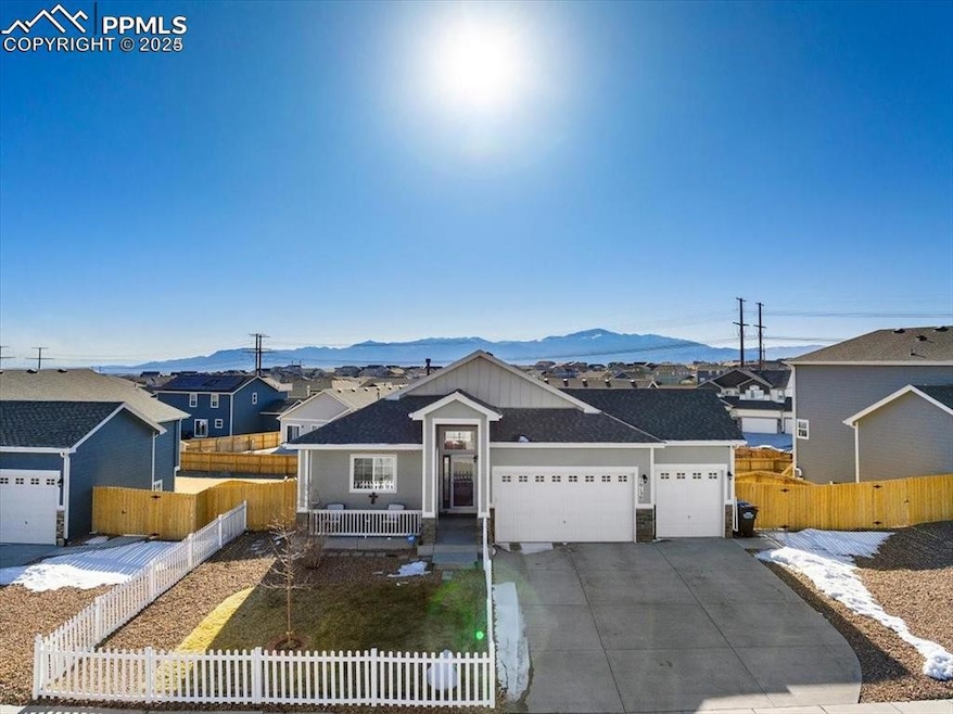 Single story home featuring driveway, a garage, fe