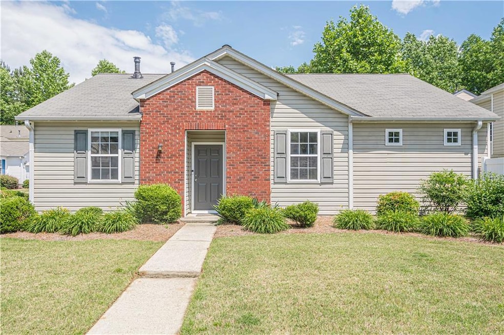 View of front of home with a front lawn, brick sid