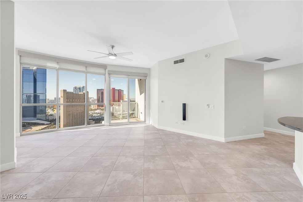 Empty room with a view of city, baseboards, visibl
