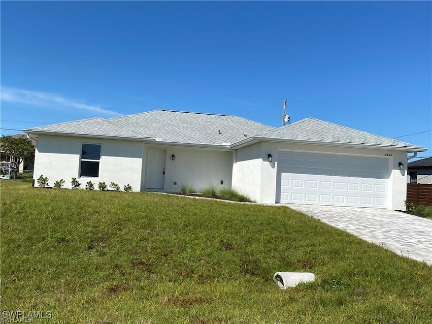 Ranch-style house with a front lawn and a garage