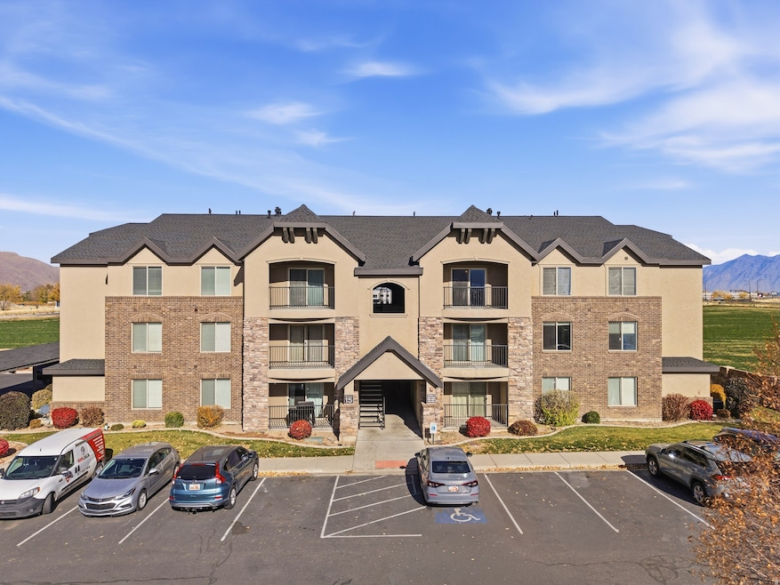 View of building exterior featuring a mountain view and uncovered parking