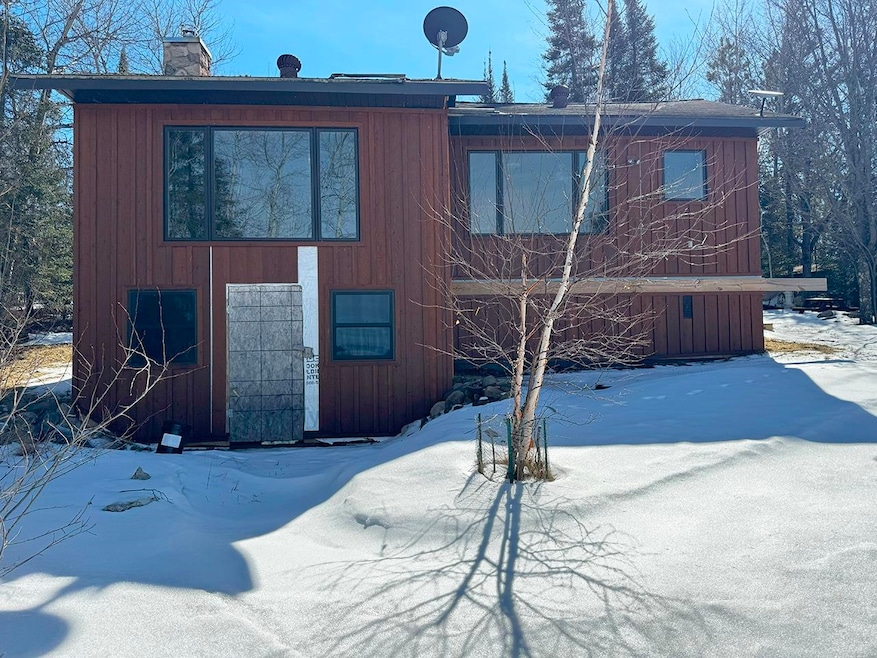 Snow covered property featuring board and batten s