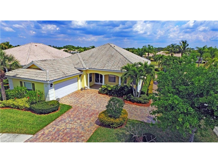 Ariel view highlighting extended paver brick driveway and mature landscaping.