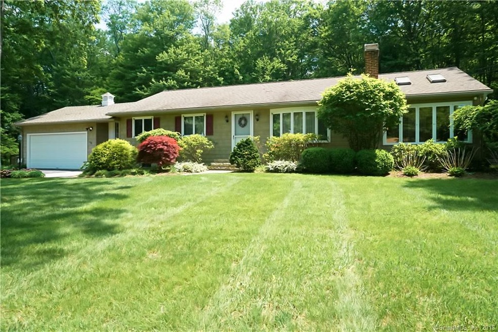 Front exterior shows 2 car garage an beautiful gre