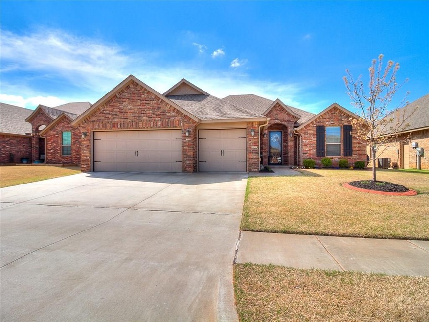 FRONT OF HOME WITH LANDSCAPED YARD. 3 CAR GARAGE W
