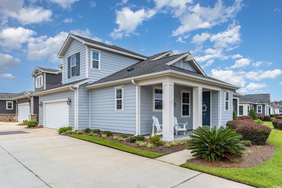 View of front of home with a garage and a porch