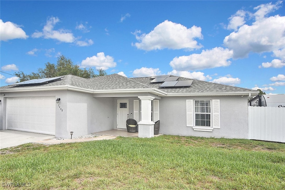 View of front of property featuring solar panels,