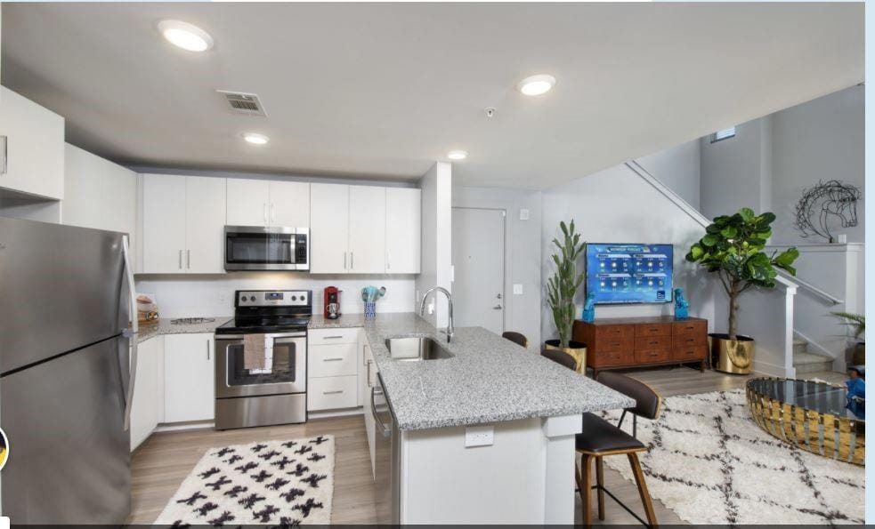 Kitchen with white cabinetry, stainless steel appl