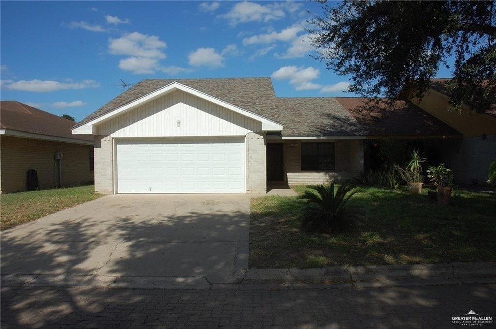 Single story home with brick siding, concrete driveway, roof with shingles, and an attached garage