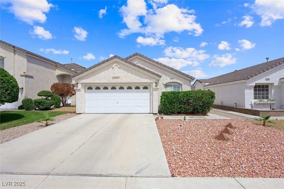 Ranch-style house with driveway, an attached garag
