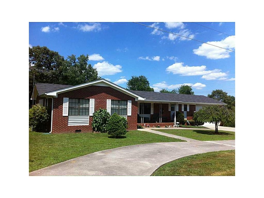 Exterior Front. 4-sided brick home with circular d