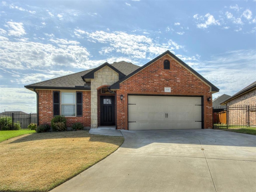 View of front of house with a front yard and a gar