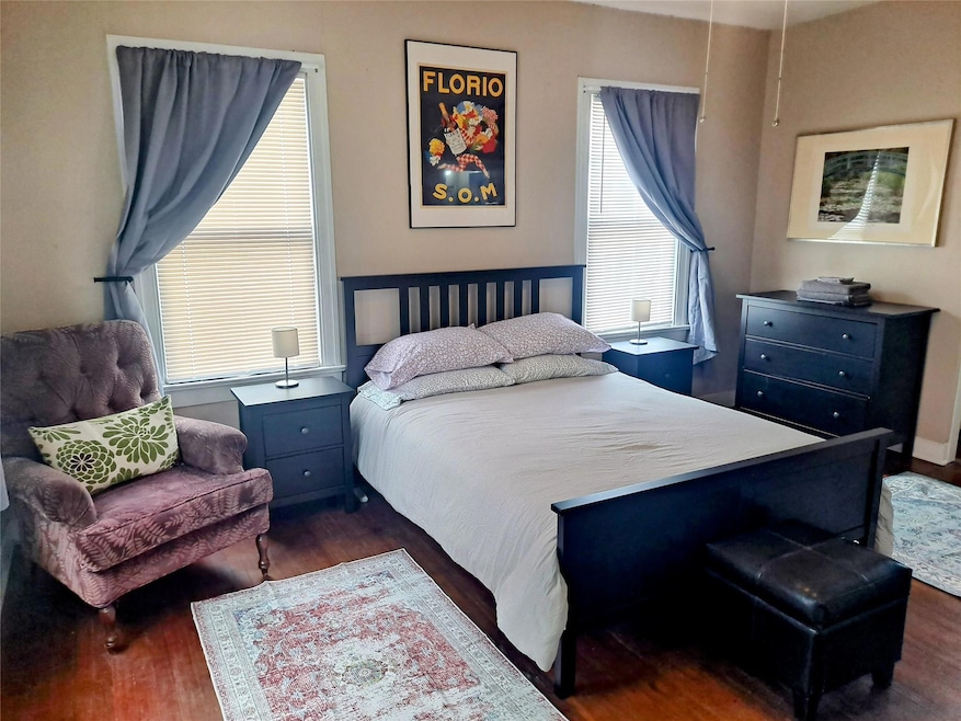 Bedroom featuring dark wood-style flooring
