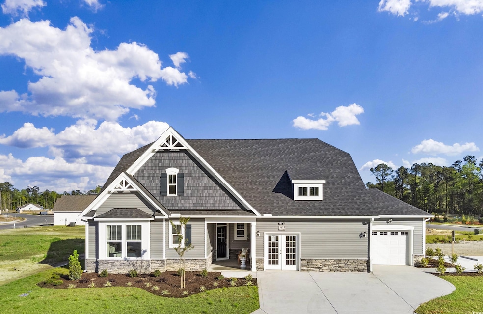 Craftsman house with french doors, stone siding, an attached garage, and concrete driveway. 3rd bay garage is optional.