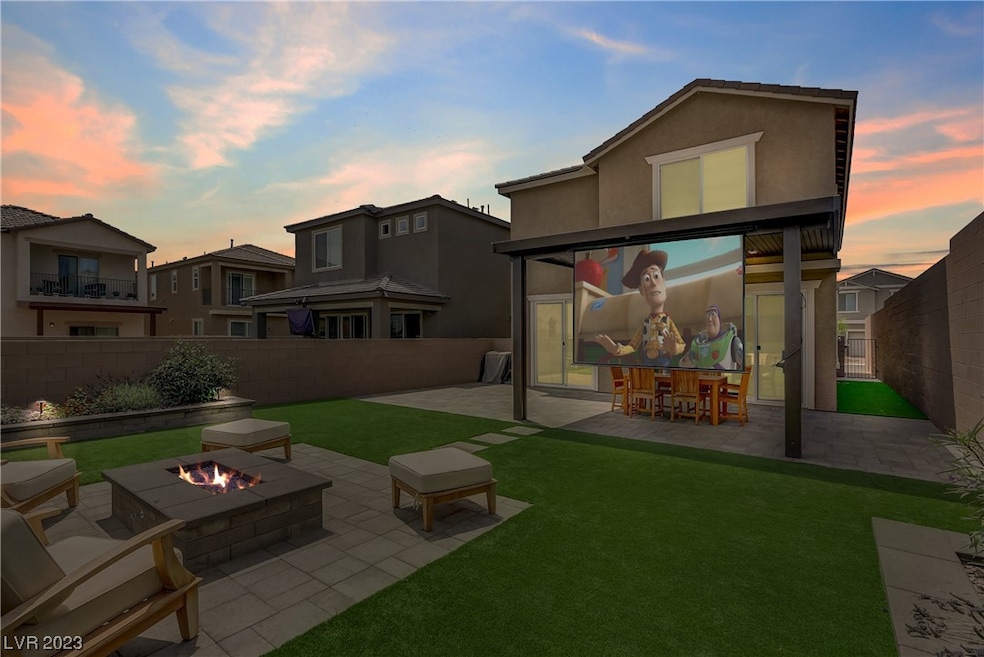 Freshly landscaped yard with firepit and projectio