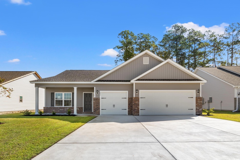 Craftsman house featuring a garage and a front law