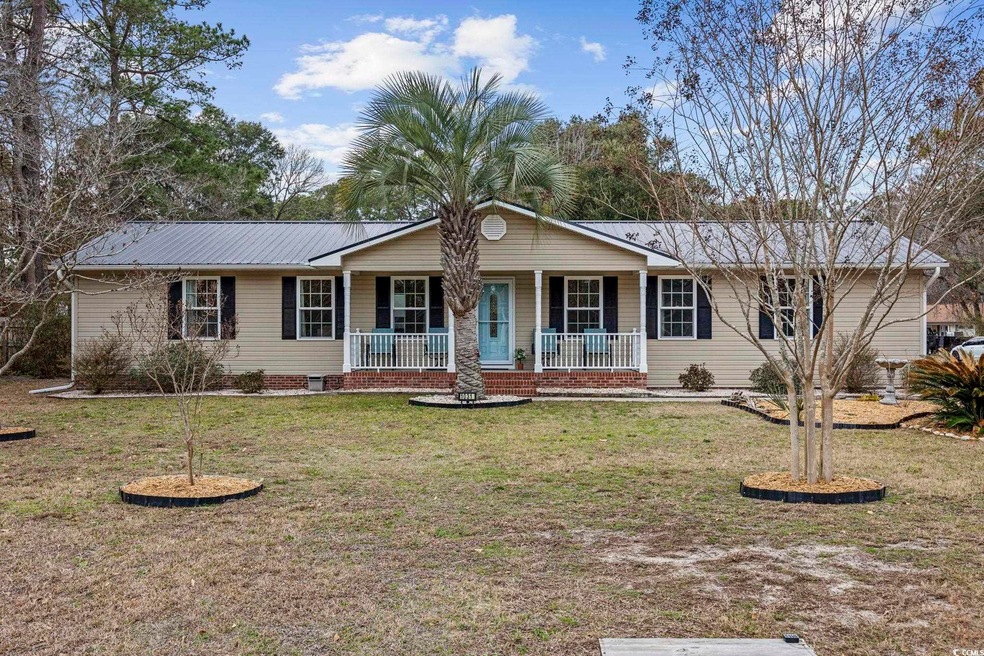 Ranch-style home with covered porch and a front la