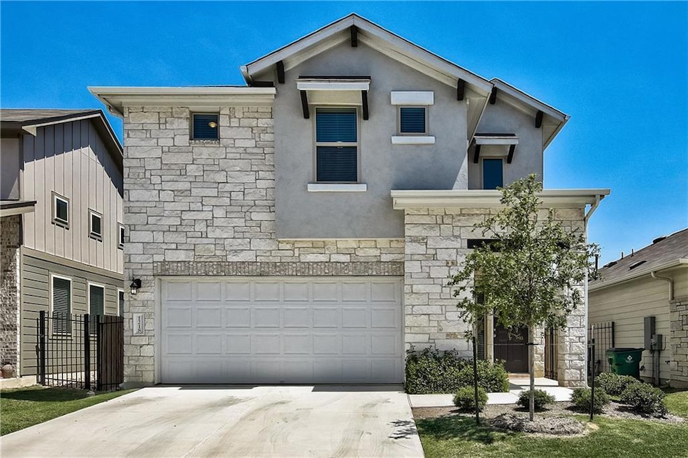 View of front of house featuring stone siding, a 
