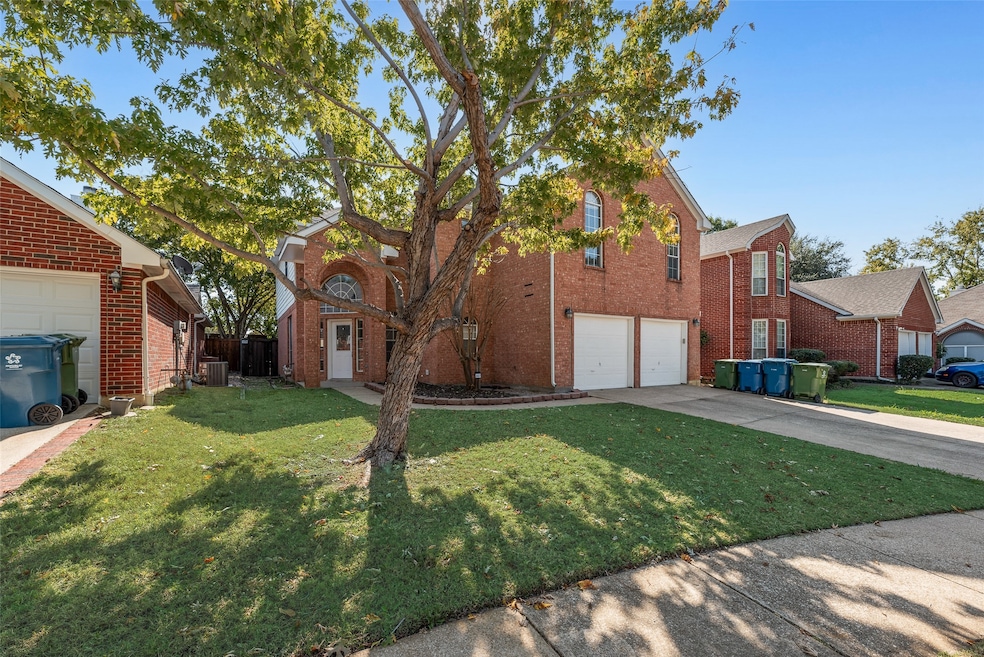 Traditional home featuring brick siding, a front lawn, and​​‌​​​​‌​​‌‌​​‌​​​‌‌​​​​​​‌‌‌​​‌​​‌‌​​​‌ driveway