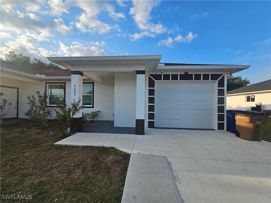 View of front facade featuring concrete driveway,