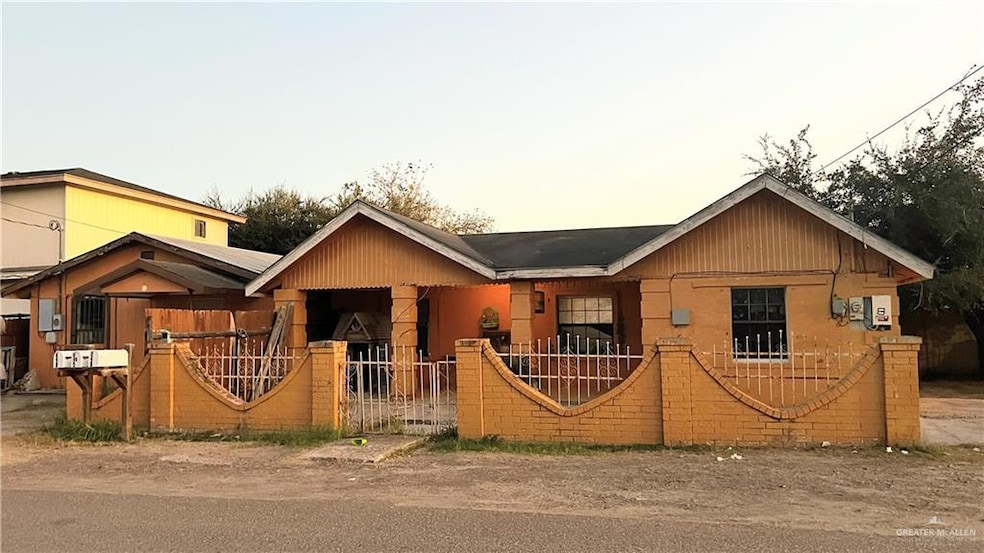 View of front facade with a fenced front yard and a gate