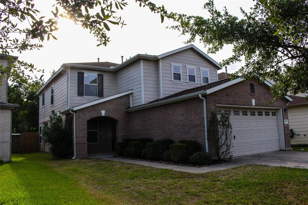Welcome home to 11907 Madison Oak St.  Home exterior features a brick front elevation and a covered front entrance.