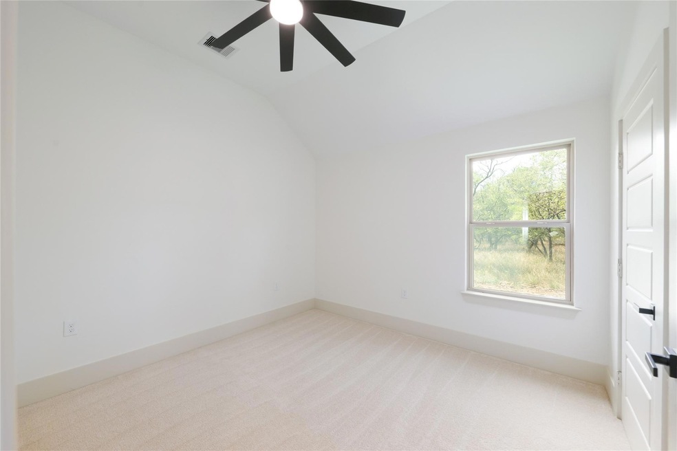 Unfurnished room with a ceiling fan, light carpet