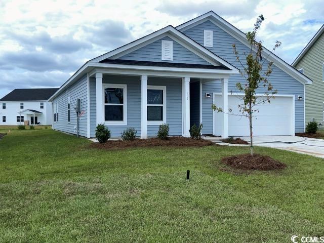 View of front of house with a garage and a front l